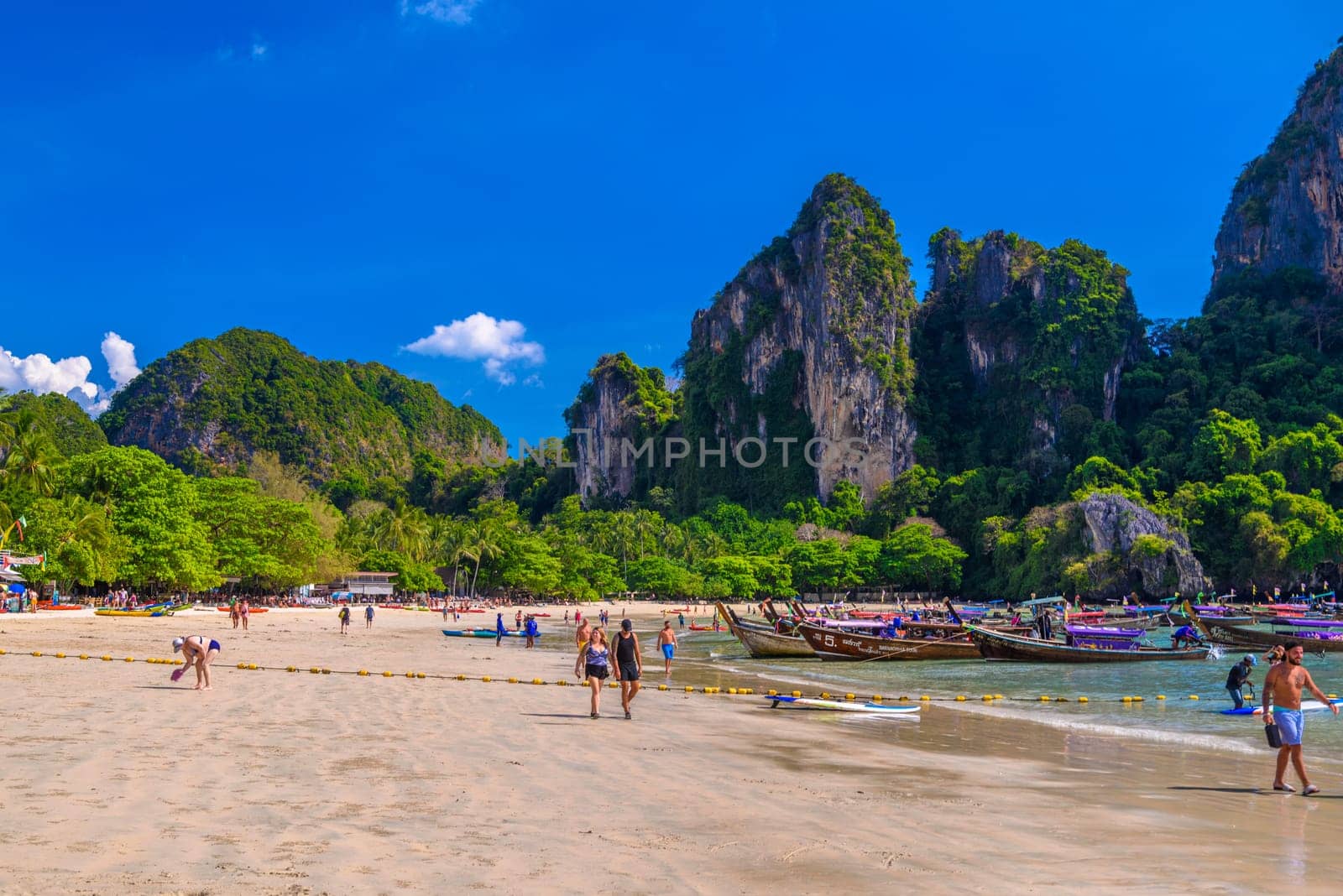 KRABI, THAILAND- MARCH 2018: Rocks, water and tropical white sand beach, Railay beach west, Ao Nang, Krabi, Thailand by Eagle2308