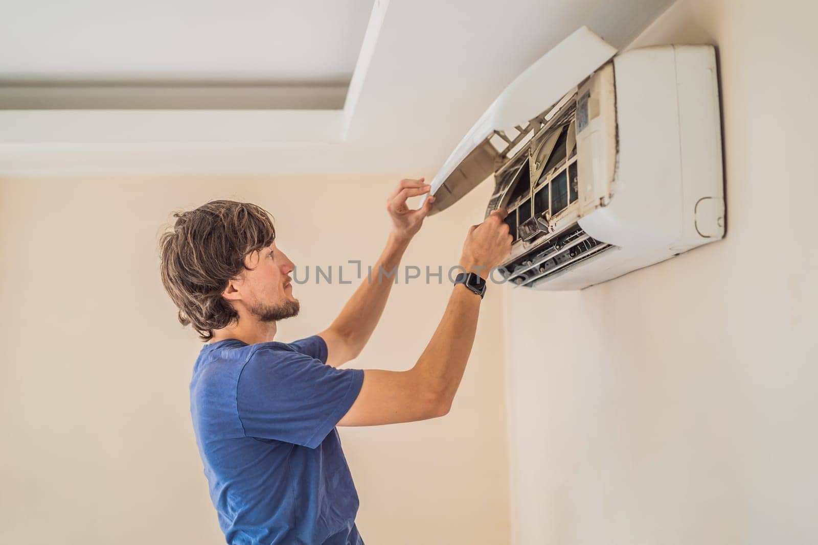 technician service removing air filter of the air conditioner for cleaning.