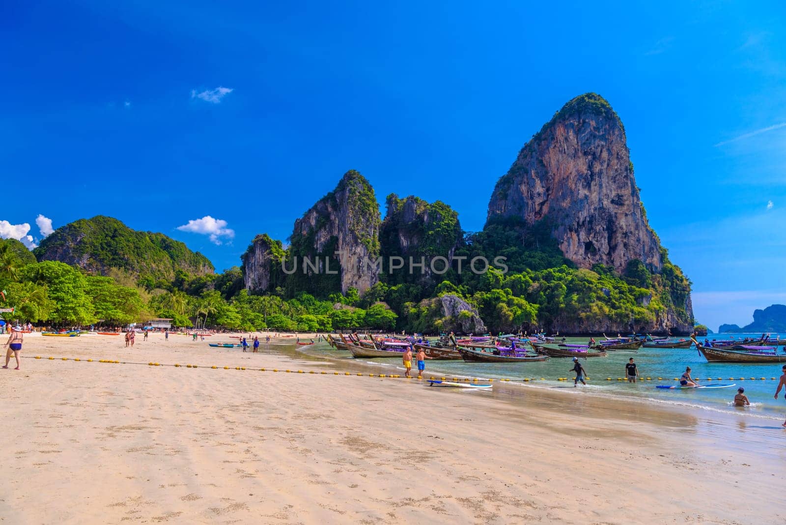 KRABI, THAILAND- MARCH 2018: Rocks, water and tropical white sand beach, Railay beach west, Ao Nang, Krabi, Thailand.