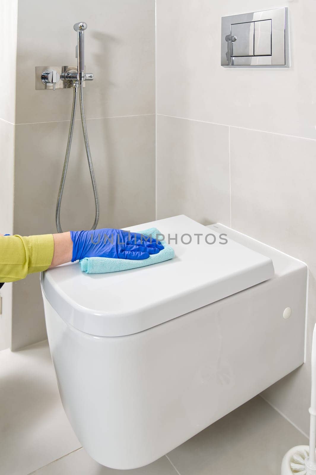 Wall mounted toilet cleaning. hotel maid cleans toilet with a scrub brush. woman household service by PhotoTime