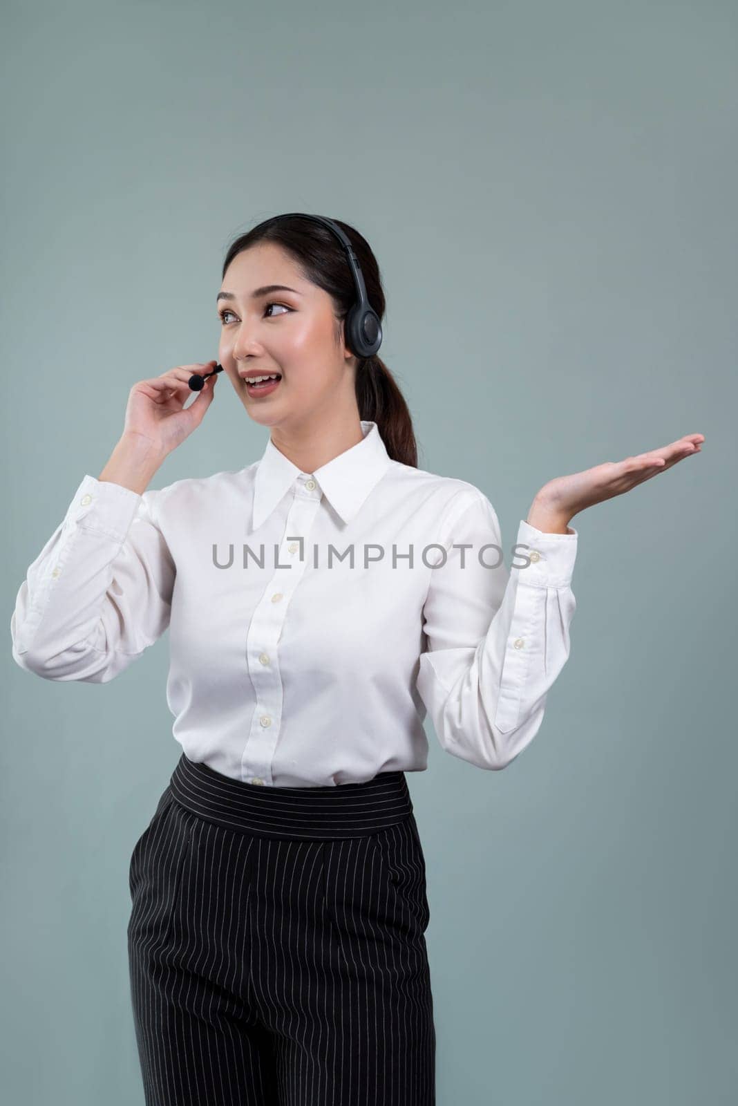 Asian operator wearing formal suit and headset with hand gesture. Enthusiastic by biancoblue