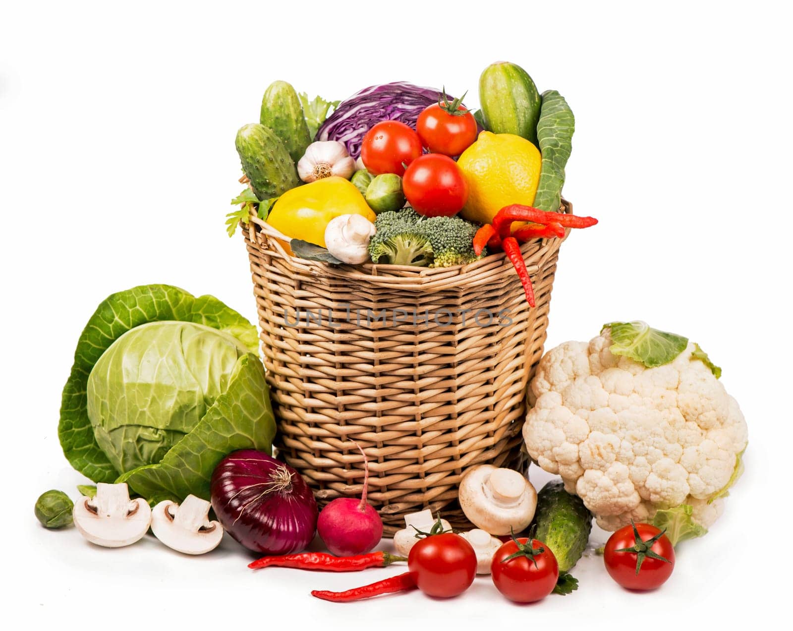 Fresh vegetables put in a wattled basket. Collection of fresh vegetables. Vegetarian diet food. fresh vegetables isolated on white. Tomatoes, broccoli, peppers, mushrooms - products for the organic market by aprilphoto