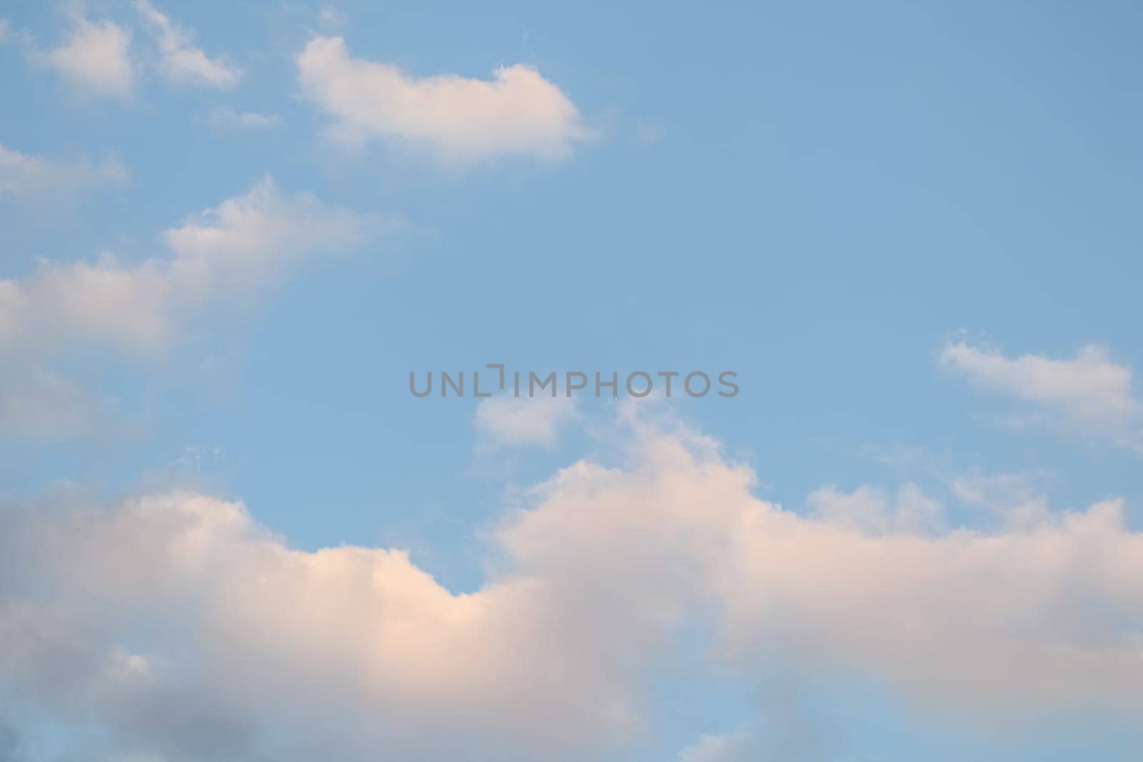 Background of blue sky with white clouds. Natural backdrop