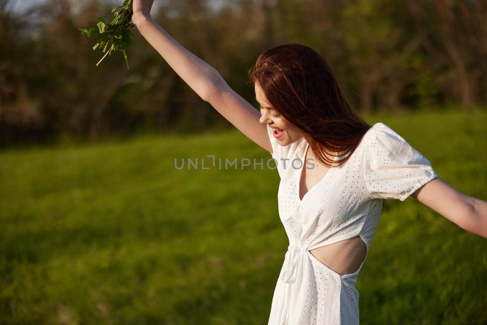 happy woman in a light dress rejoices in life with a bouquet of flowers in her hands. High quality photo