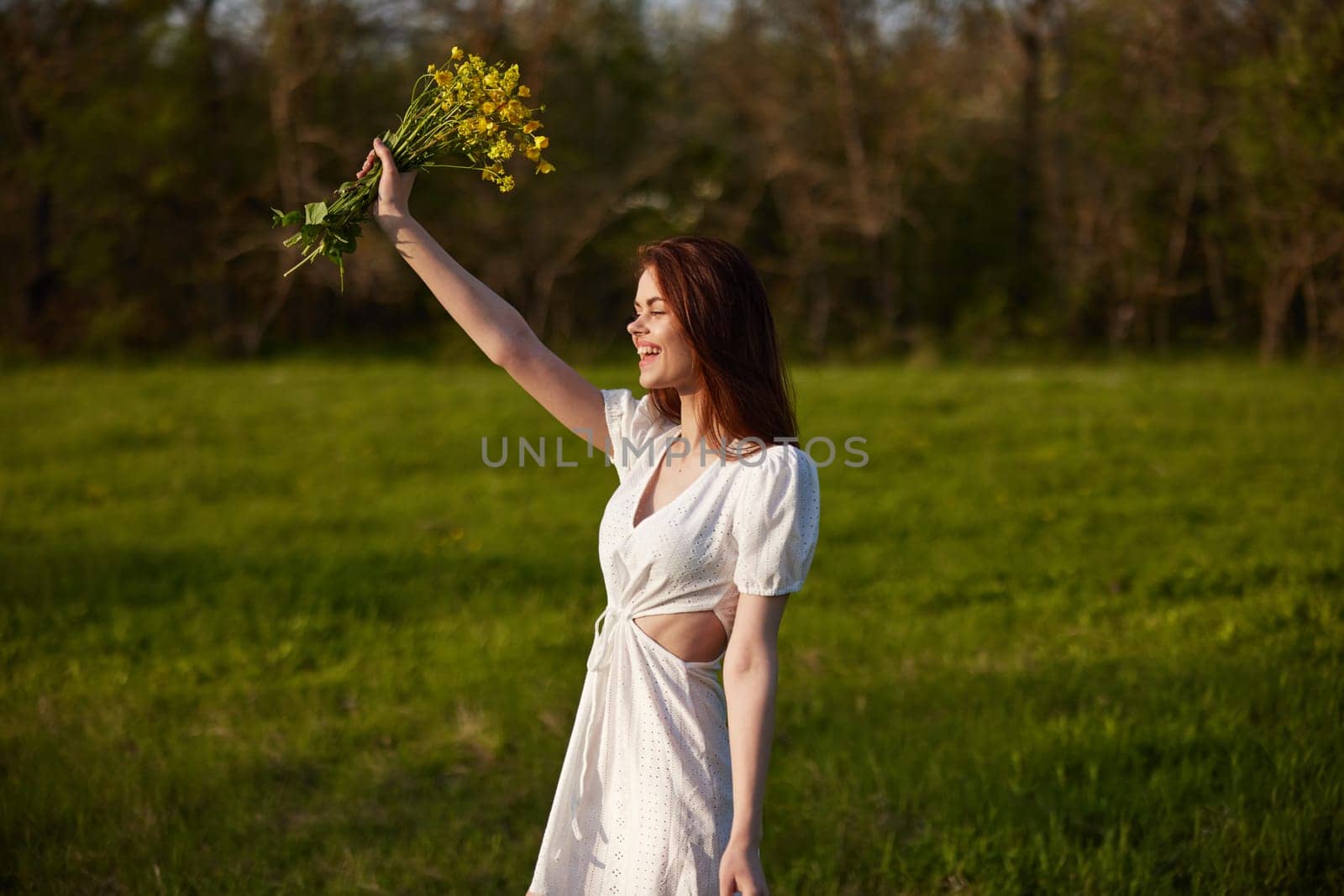 happy woman in a light dress rejoices in life with a bouquet of flowers in her hands. High quality photo