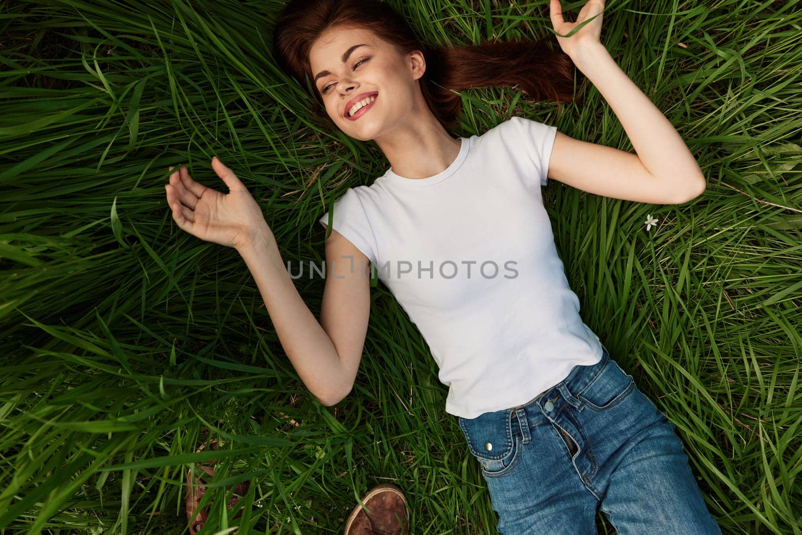 Woman dreams, lies in the grass . High quality photo