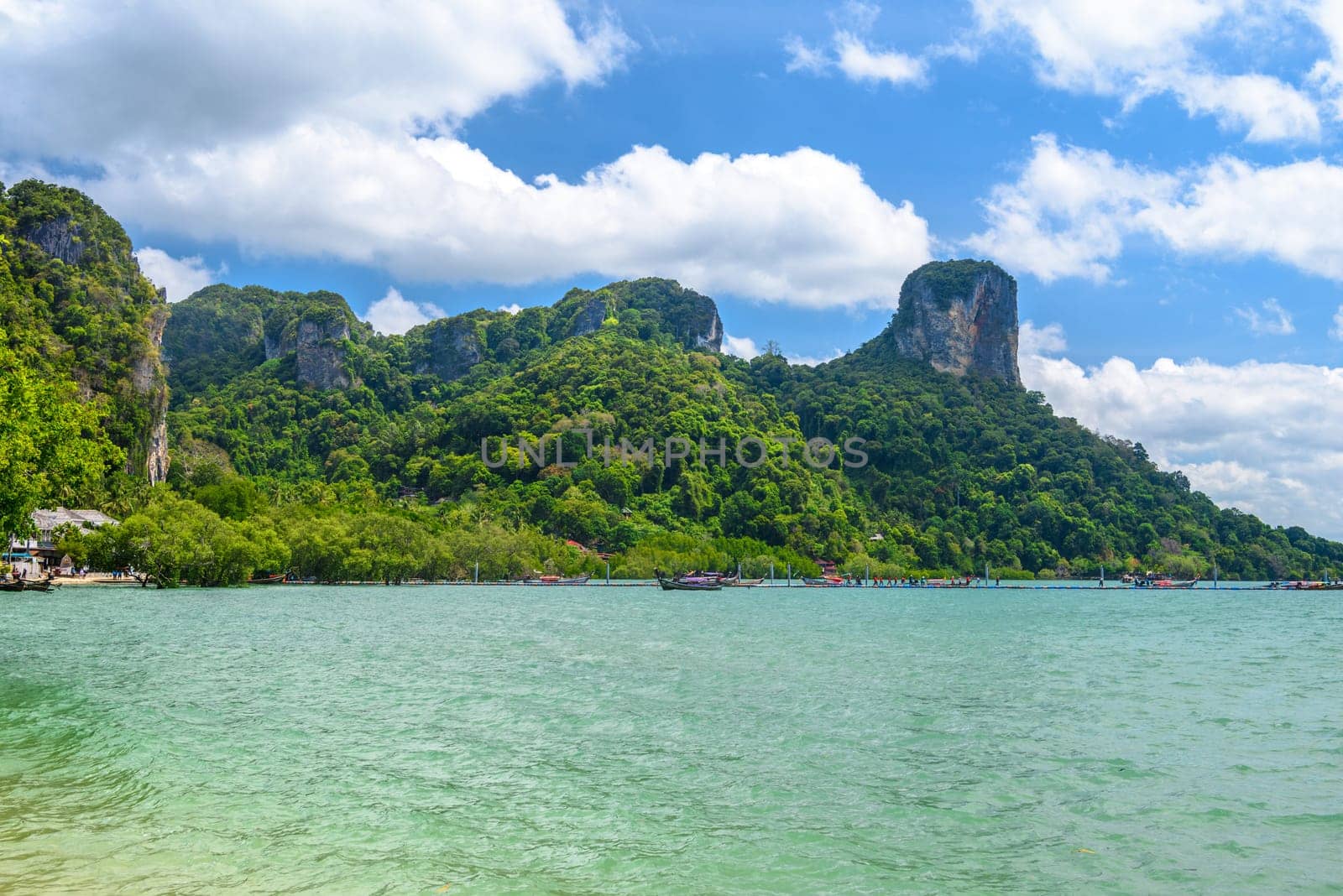 Rocks and cliffs covered with tropical trees, azure water on Ao Phra Nang Beach, Railay east Ao Nang, Krabi, Thailand.