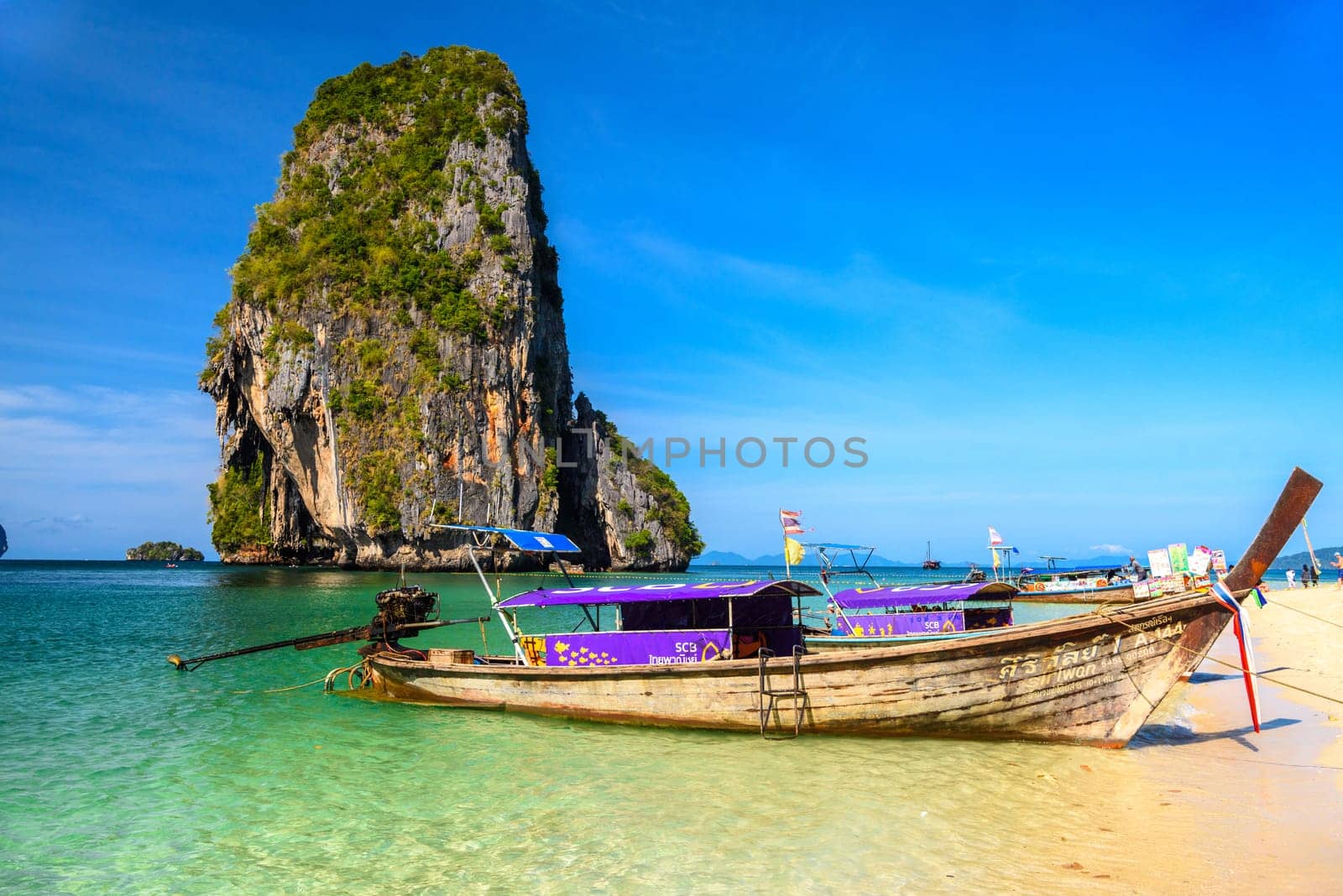 KRABI, THAILAND- MARCH 2018: Long tail boats and cliff rock in azure water, Ko Rang Nok, Ao Phra Nang Beach, Ao Nang, Krabi, Thailand by Eagle2308