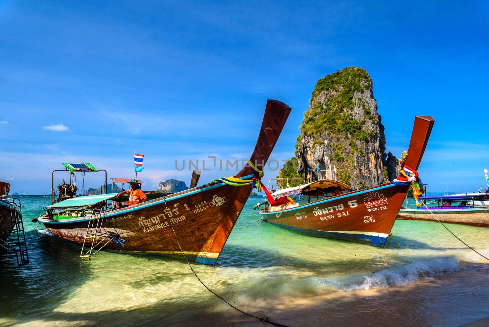 KRABI, THAILAND- MARCH 2018: Long tail boats and cliff rock in azure water, Ko Rang Nok, Ao Phra Nang Beach, Ao Nang, Krabi, Thailand by Eagle2308