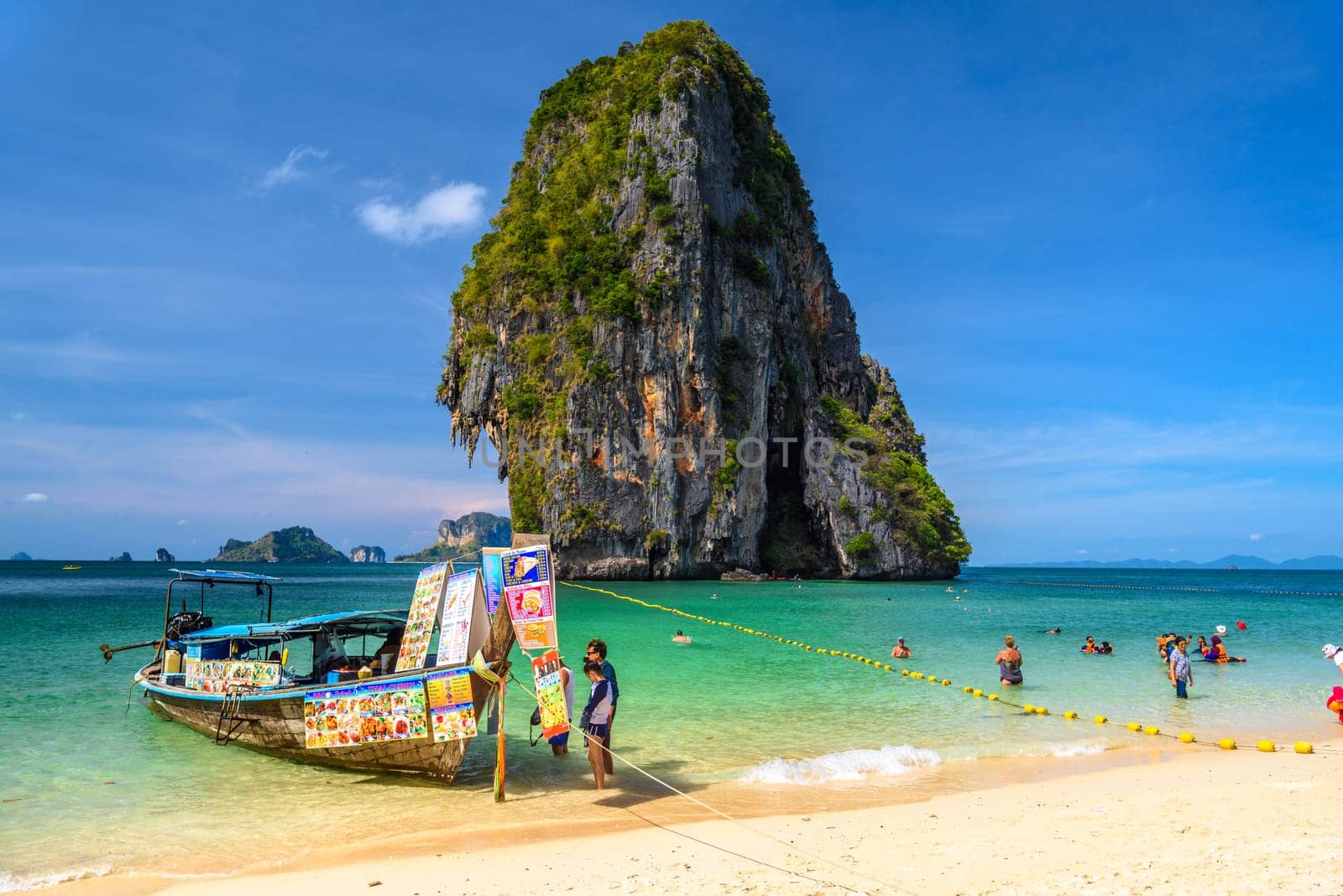 KRABI, THAILAND- MARCH 2018: Long tail boats and cliff rock in azure water, Ko Rang Nok, Ao Phra Nang Beach, Ao Nang, Krabi, Thailand.