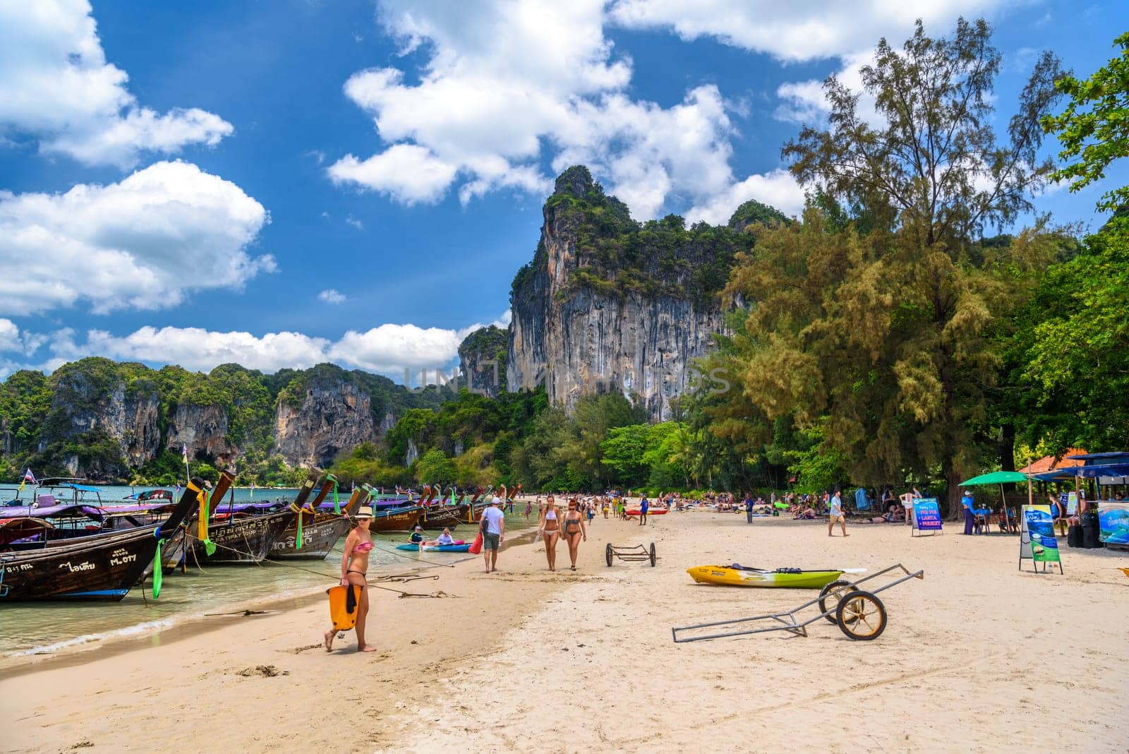 KRABI, THAILAND- MARCH 2018: Long tail boats and rocks on Railay beach west, Ao Nang, Krabi, Thailand.