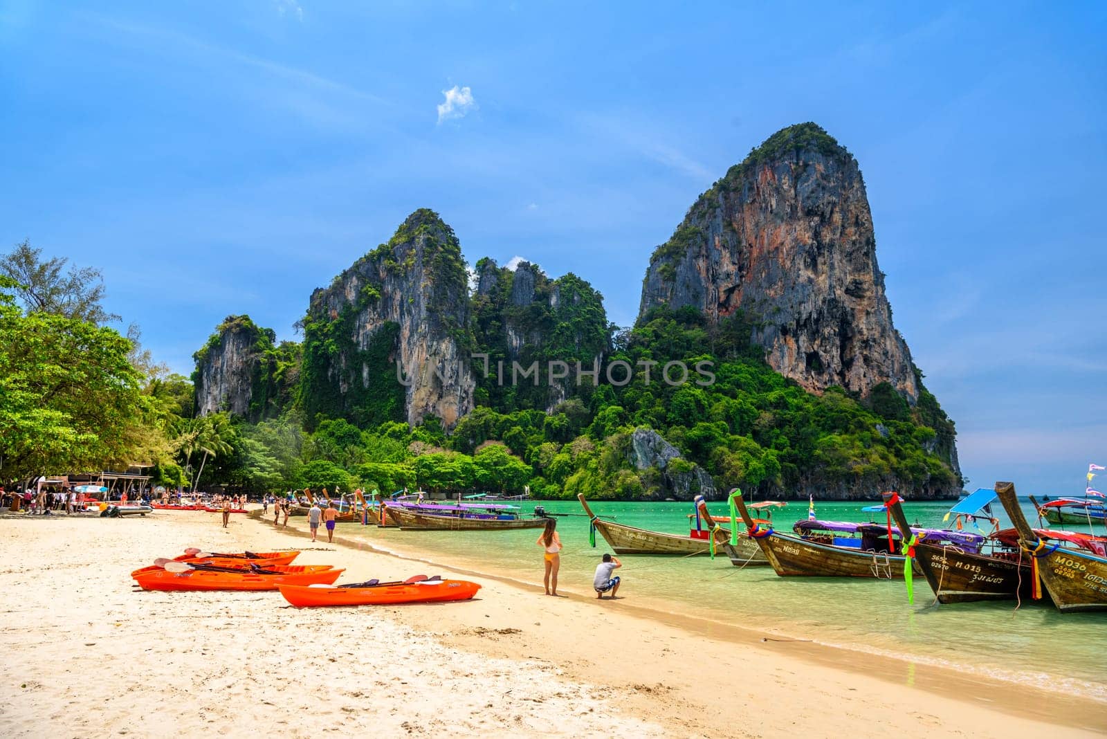 KRABI, THAILAND- MARCH 2018: Long tail boats and rocks on Railay beach west, Ao Nang, Krabi, Thailand.