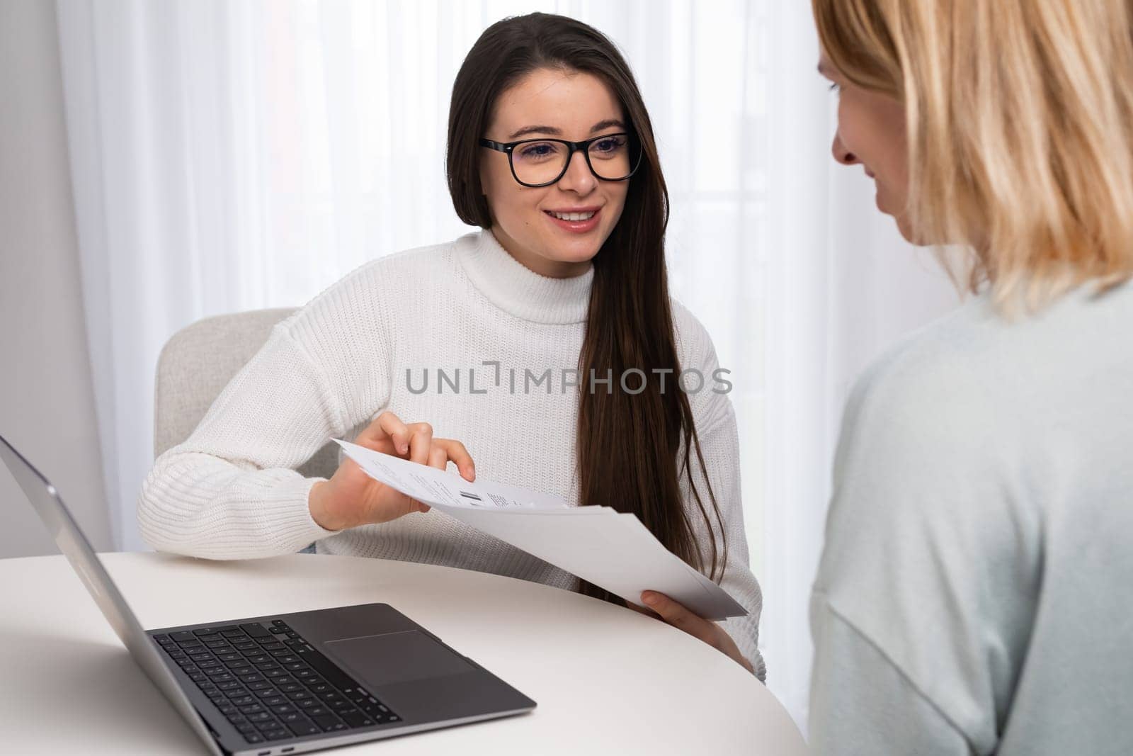 Businesswoman has an appointment with a client and shows documents