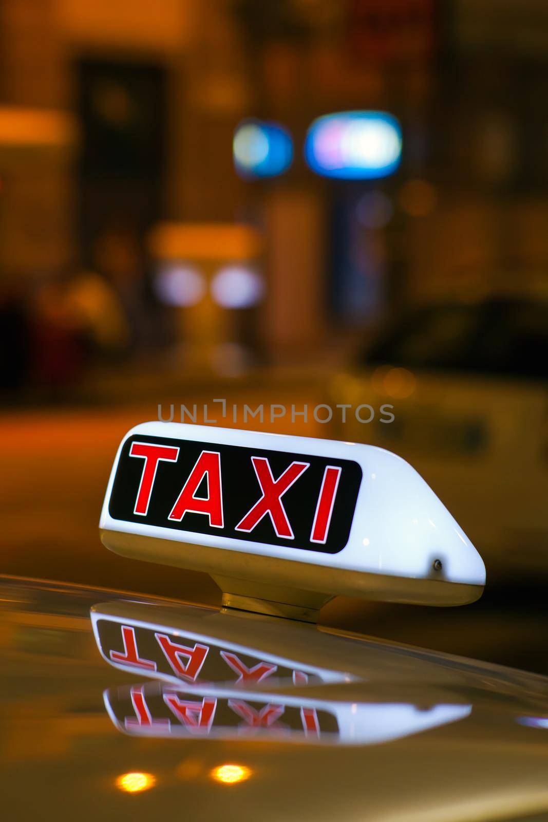Taxi sign from parked taxi in the Milan street at night