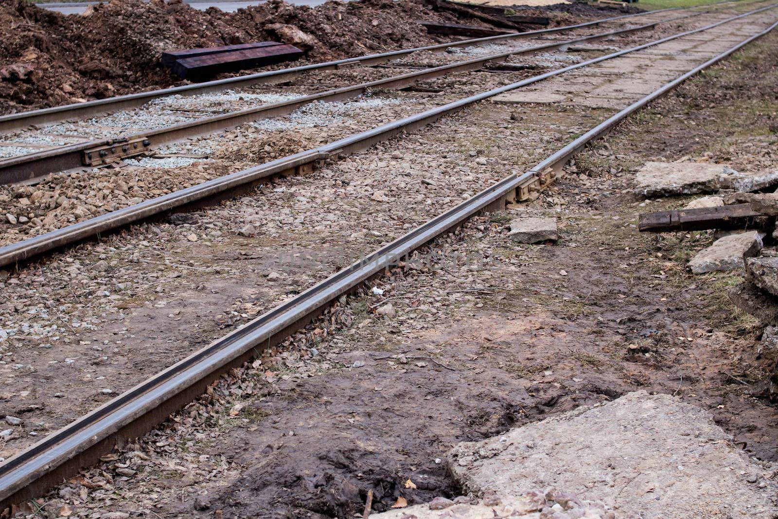 Sand on repair work on tram rails close up