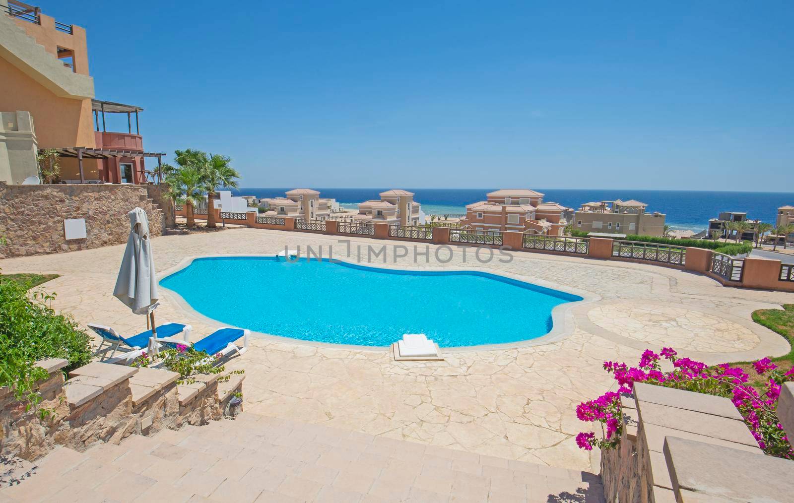 Outdoor swimming pool in a luxury tropical hotel resort by paulvinten