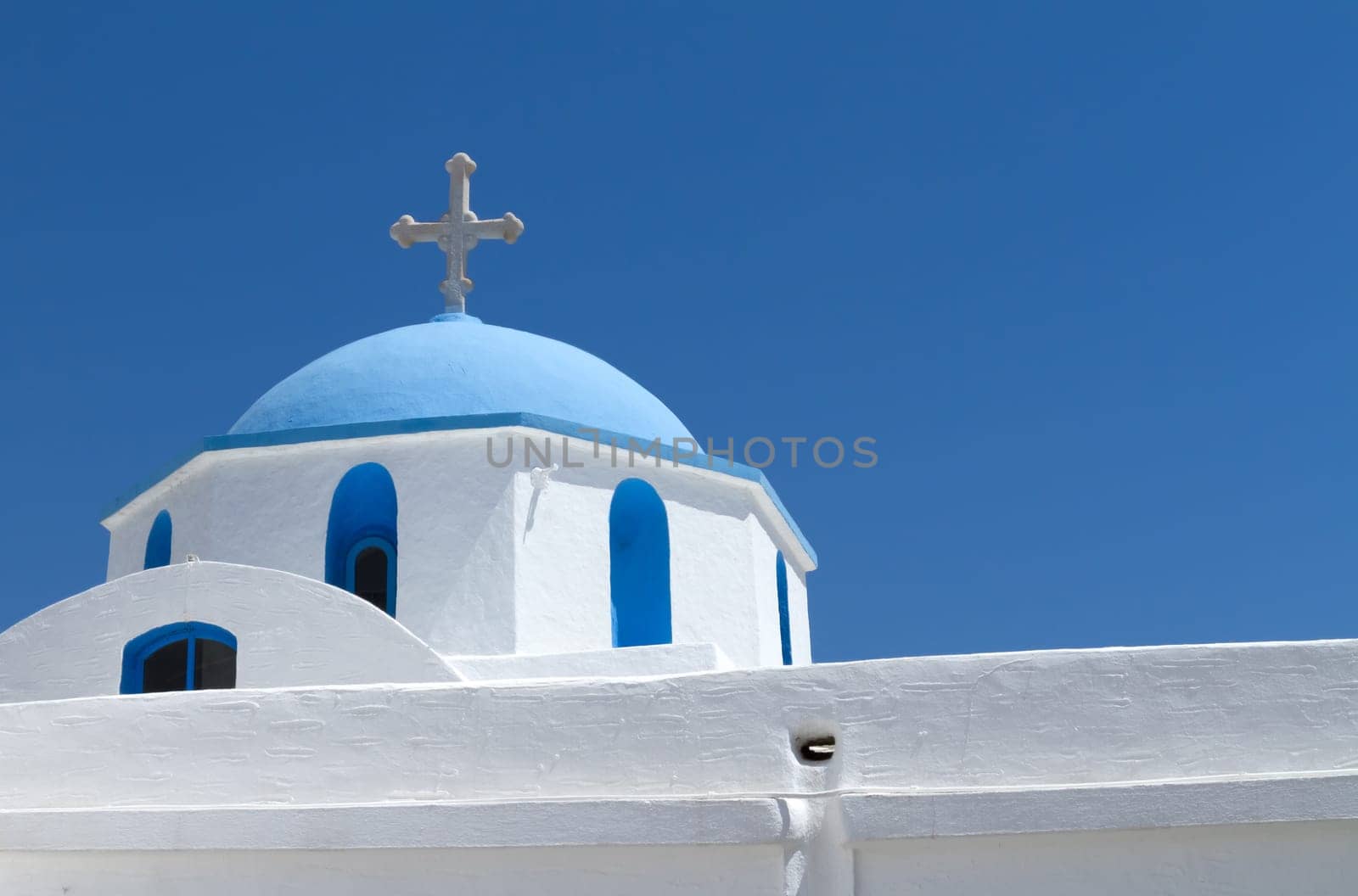 Typical church in Greece under clear blue sky - Paros Island