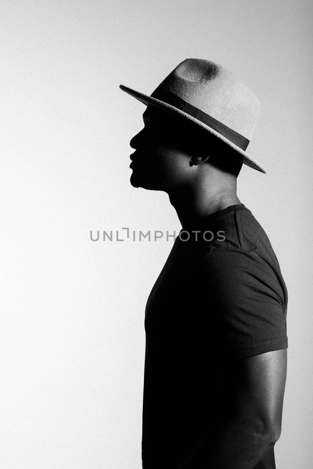 Silhouette head of sad african american man in hat on black and white isolated background by Satura86