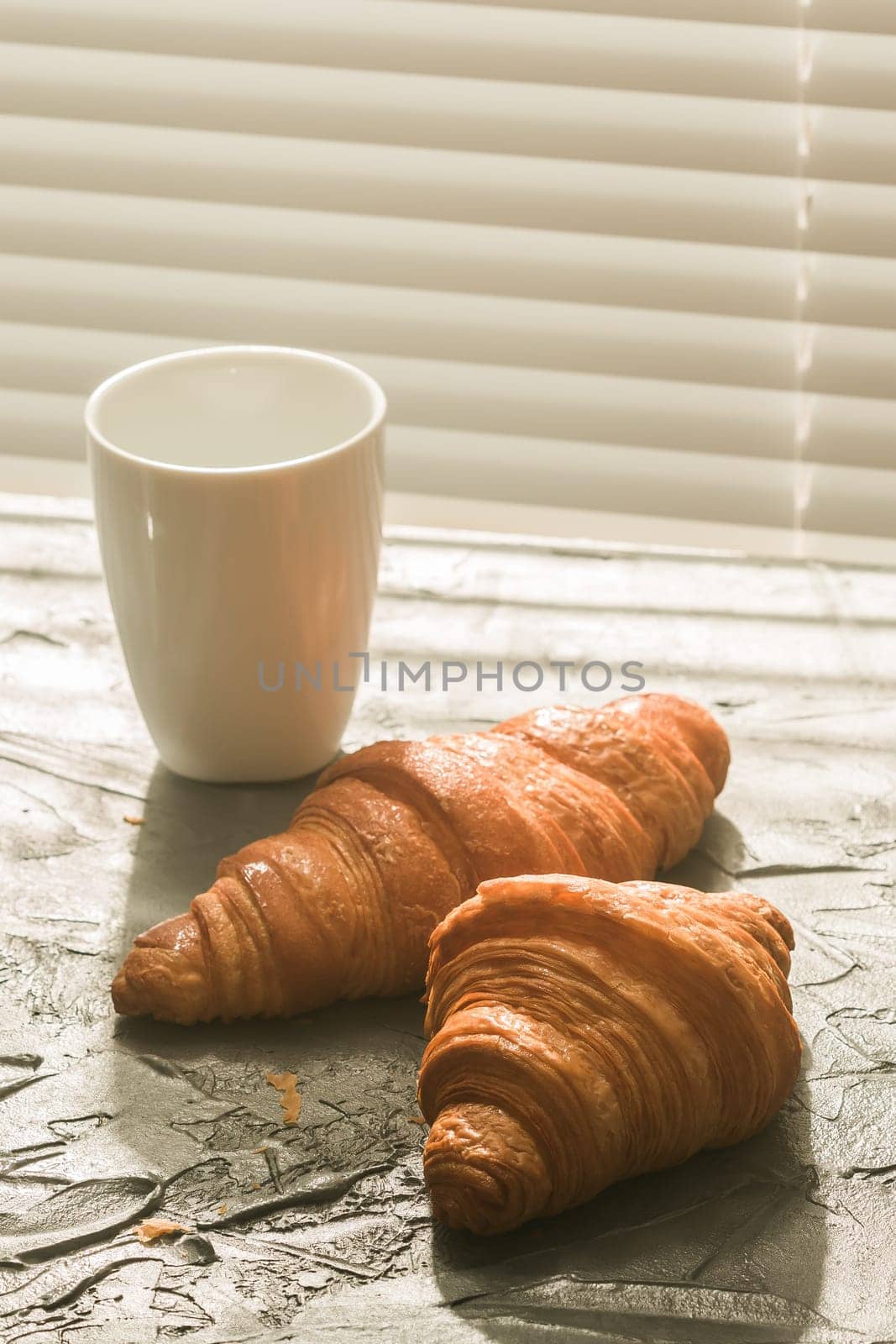 Breakfast with croissant and cup and moka pot. Morning meal and breakfast concept. by Satura86