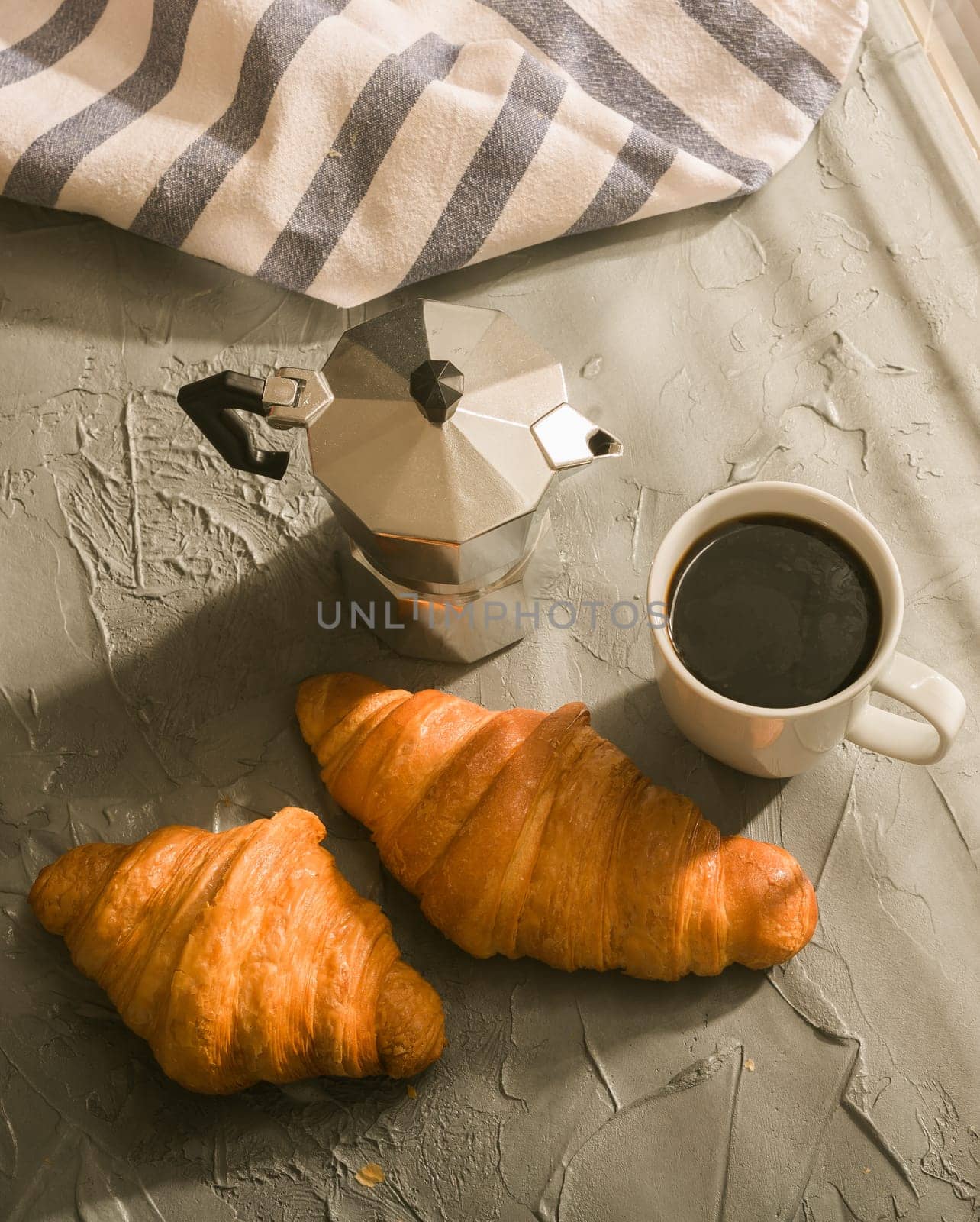 Breakfast with croissant and coffee and moka pot. Morning meal and breakfast concept. Top view. by Satura86