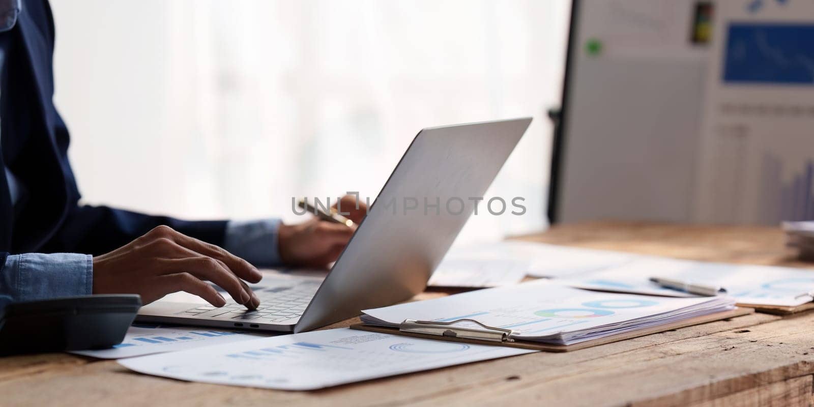 Close up Accountant man working with calculator and do document, tax, exchange, accounting and Financial advisor concept.