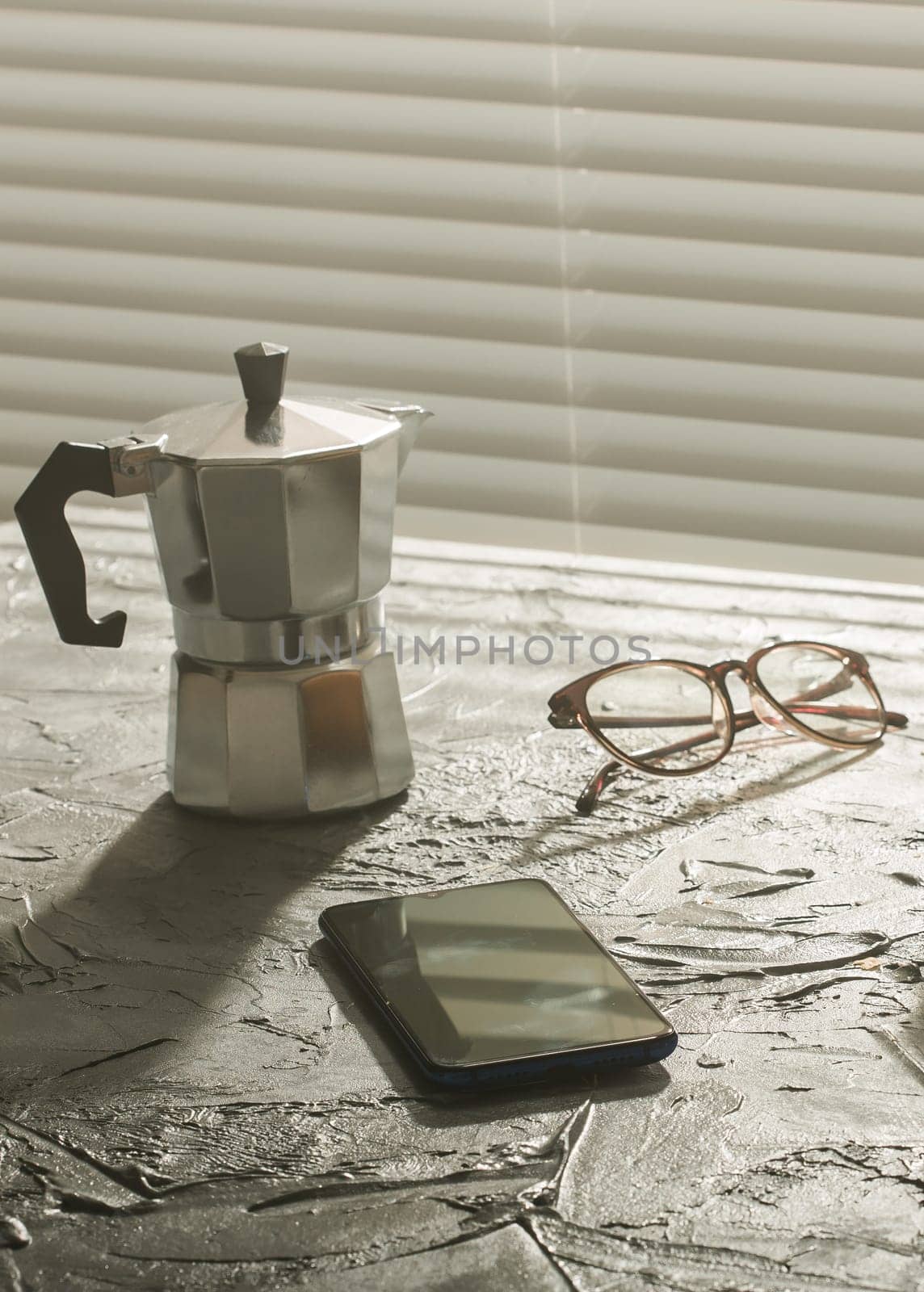 Breakfast with coffee moka pot and smartphone and eyeglasses. Morning meal and breakfast concept. by Satura86
