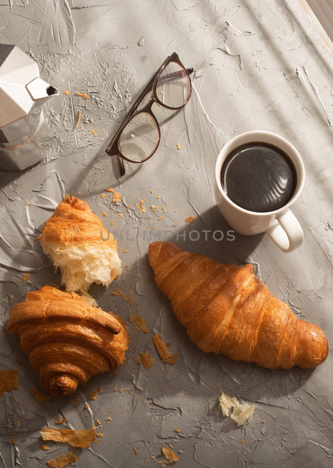 Breakfast with croissant and black coffee and eyeglasses. Morning meal and breakfast concept. Top view. by Satura86