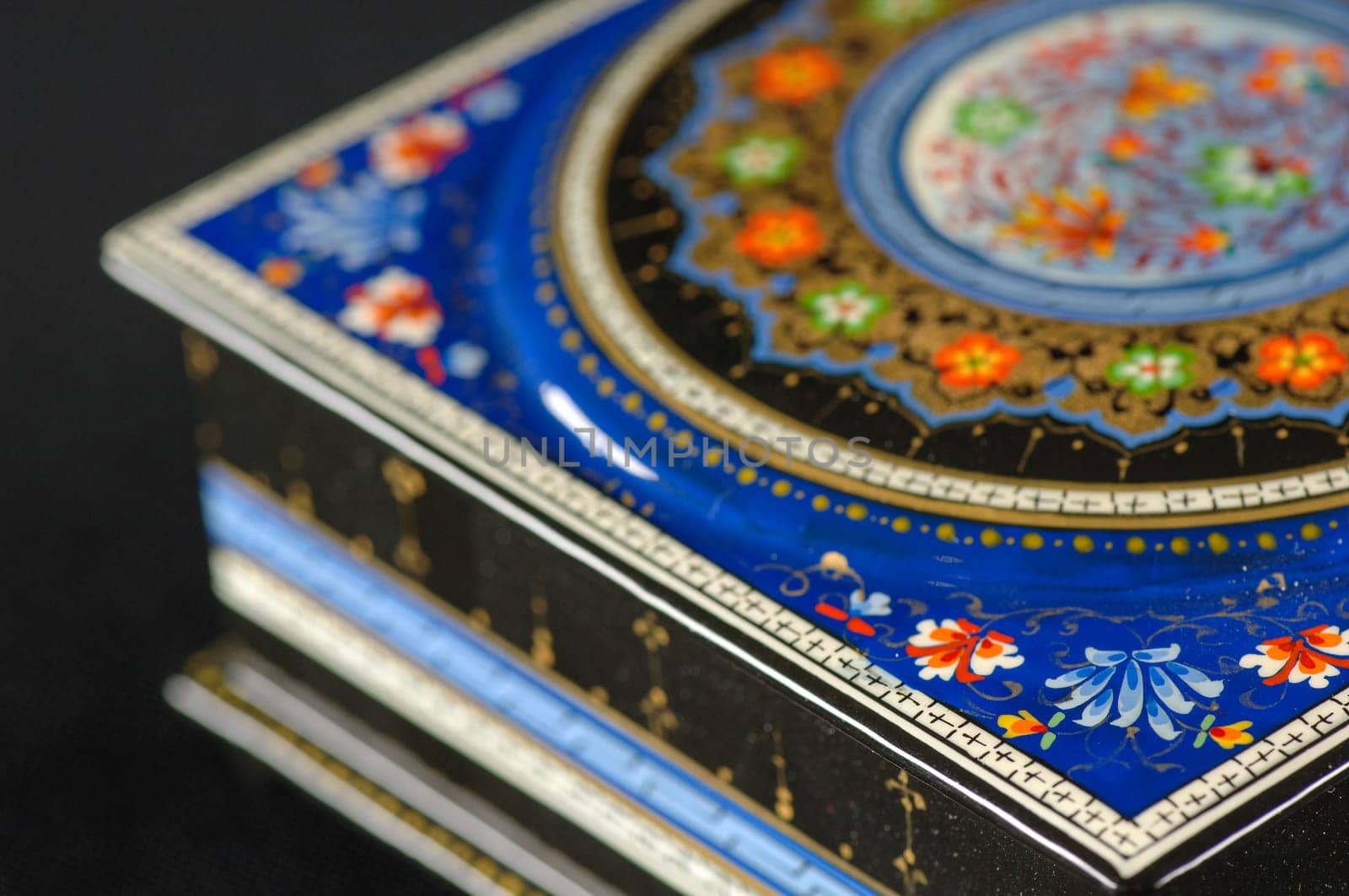 A closeup of a casket with an artistic painting on a black background. Central Asia, Uzbekistan