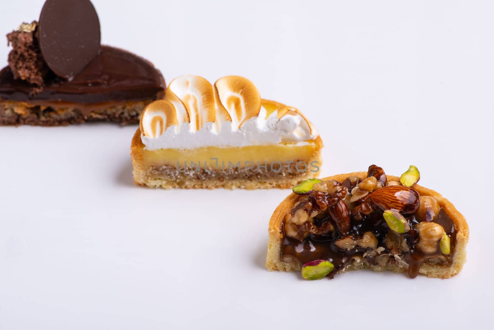 A Three pieces of cakes cut in half isolated on a white background