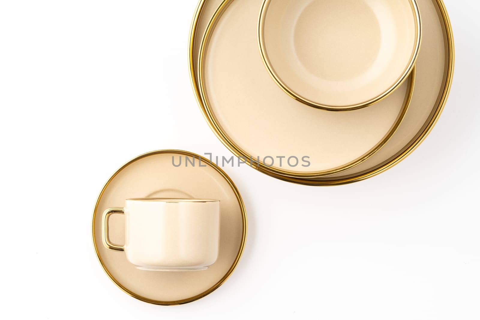A Set of light brown ceramic plate and cup on a white background. Top view