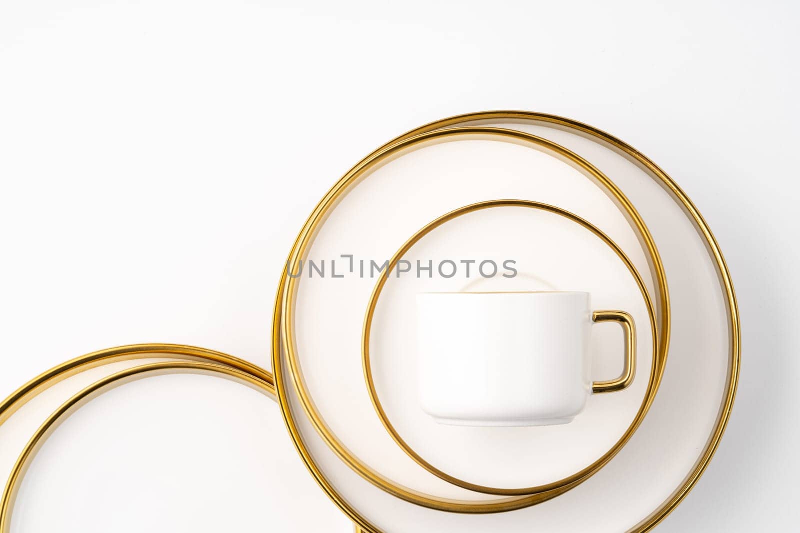 A set of white and brown ceramic plate and cup on a white background. Top view by A_Karim