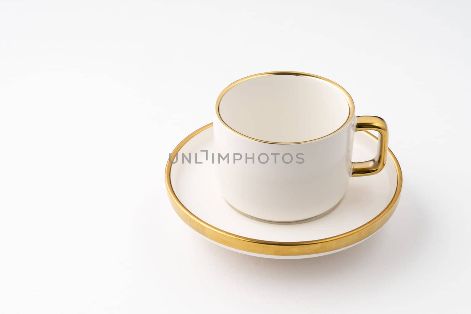 A set of white and brown ceramic plate and cup on a white background