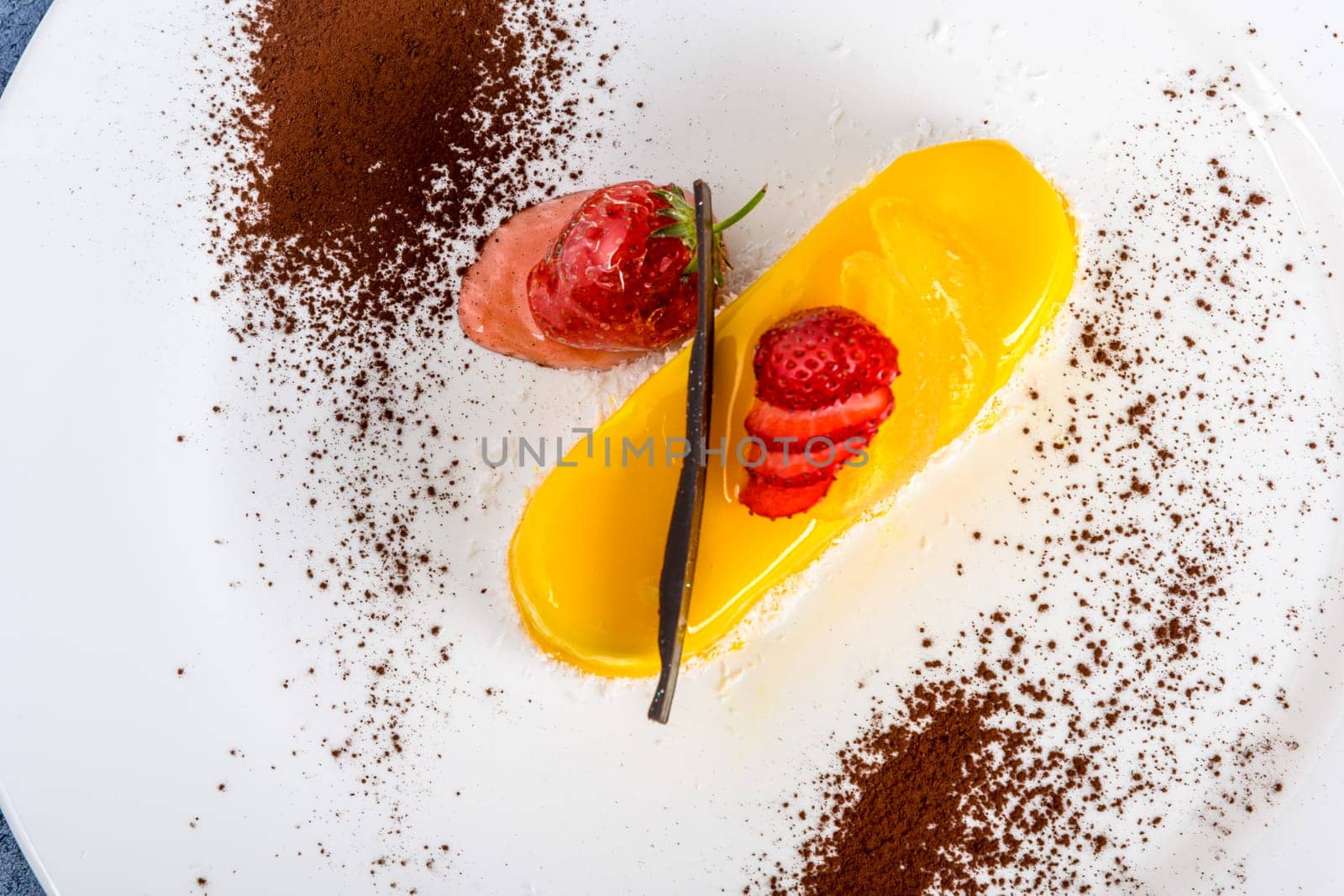 A closeup top view shot of a lemon cake with strawberries by A_Karim