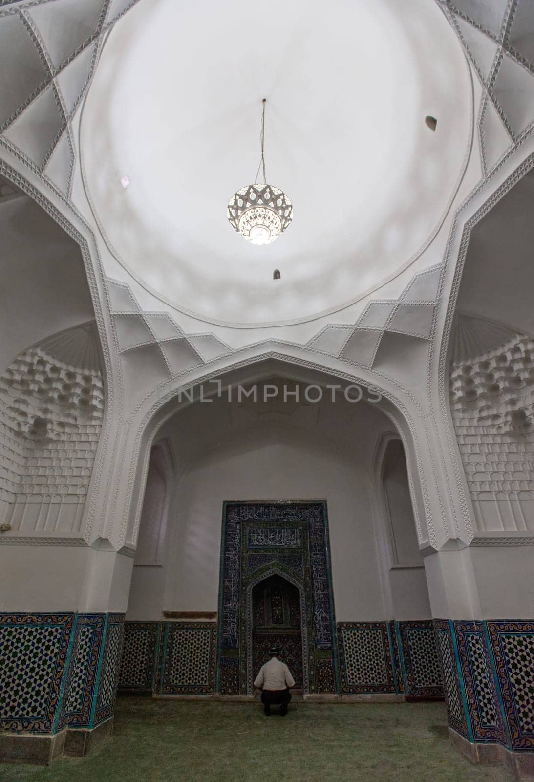 A man praying in the mosque in Samarkand, Uzbekistan by A_Karim