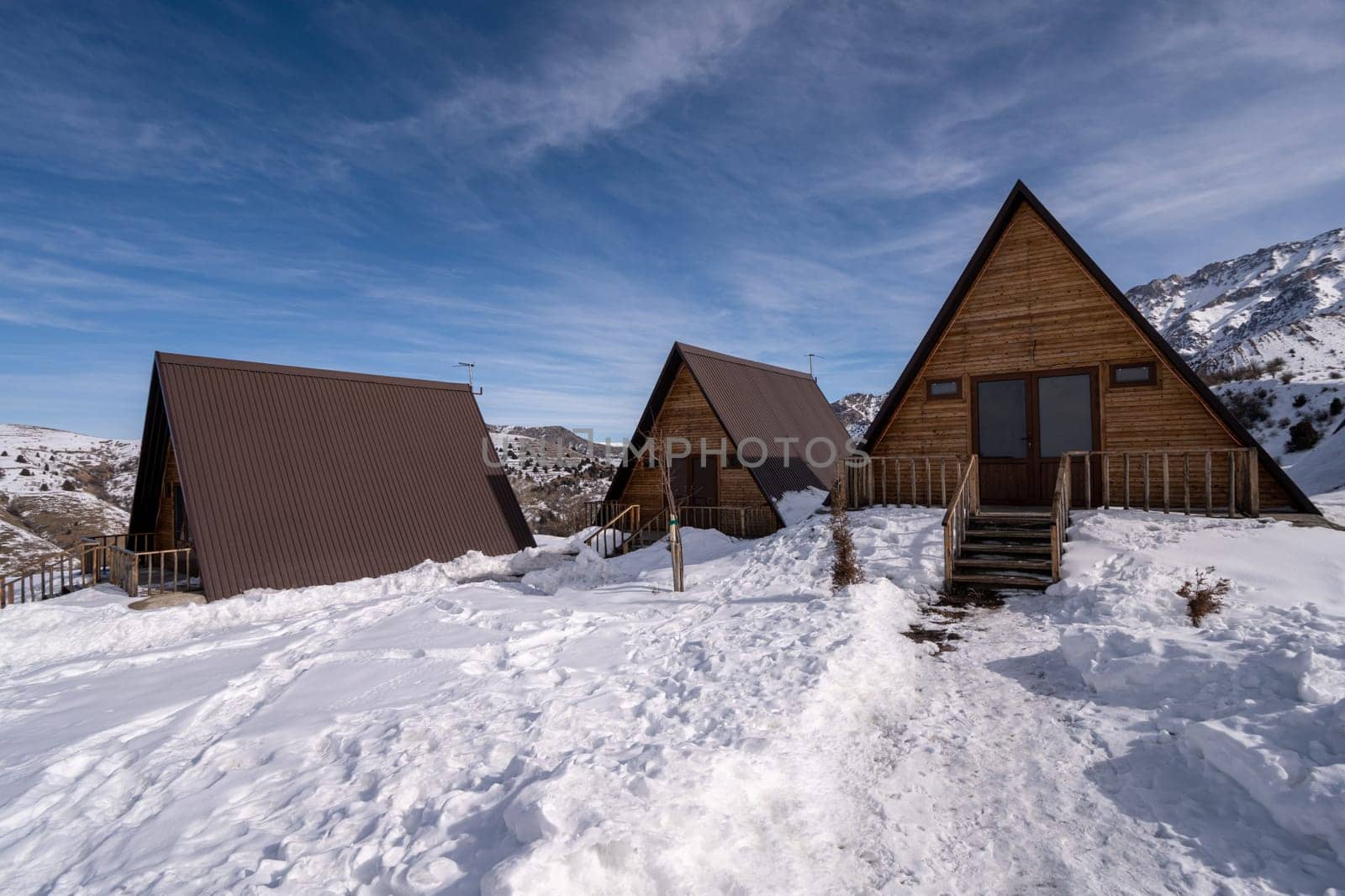 The wooden cottages surrounded by snow. A recreation area in the mountains by A_Karim