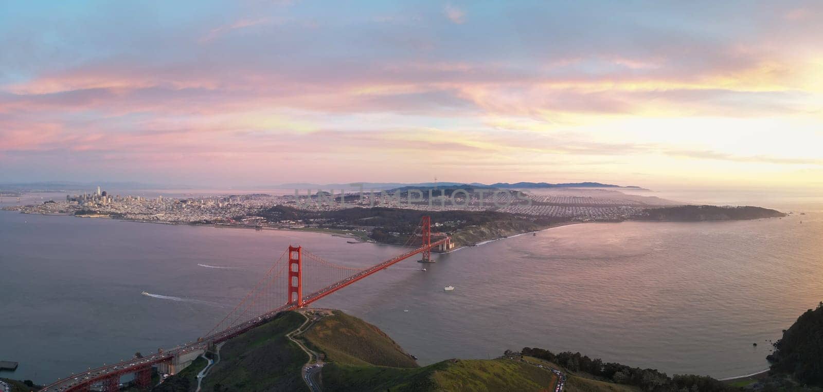 Panoramic view of Golden Gate Bridge and San Francisco at sunset. High quality photo