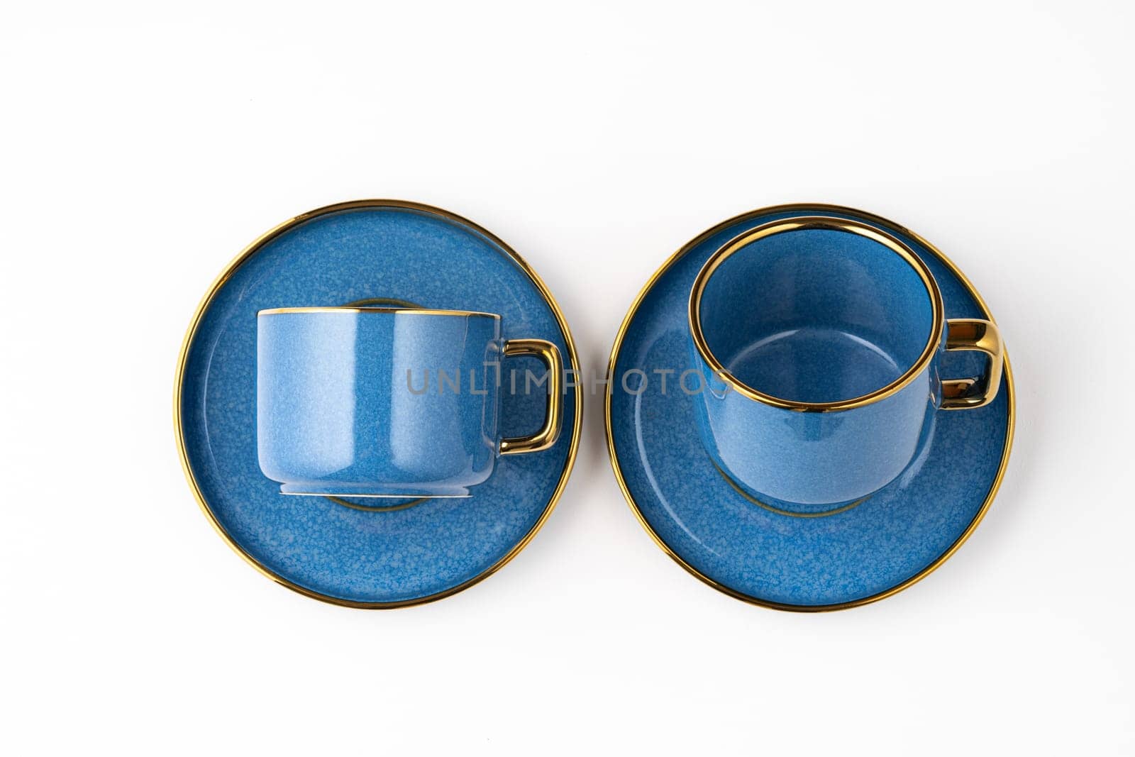 A set of blue ceramic plates and cup on a white background. Top view by A_Karim