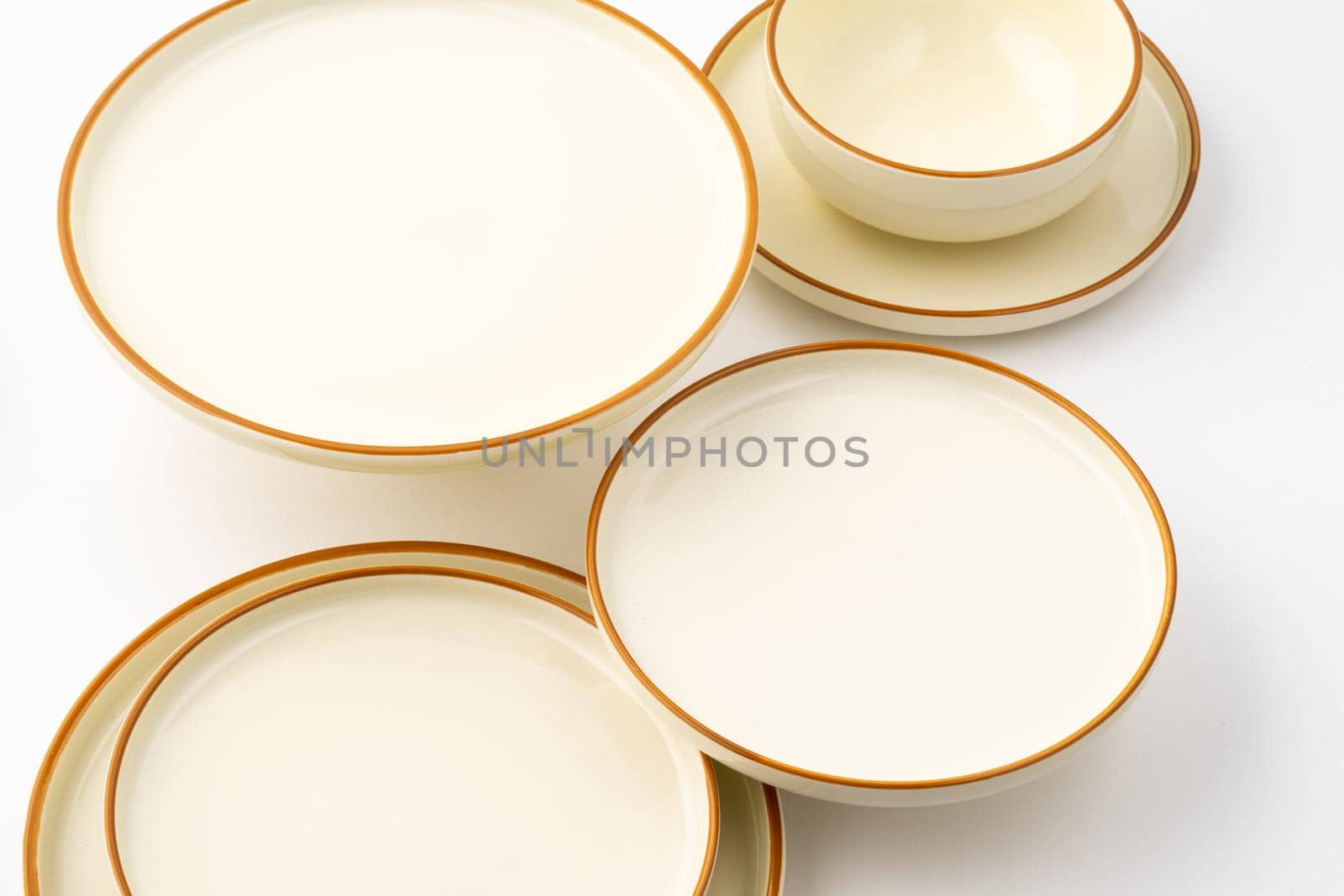 A set of white and brown ceramic plate and bowl on a white background by A_Karim