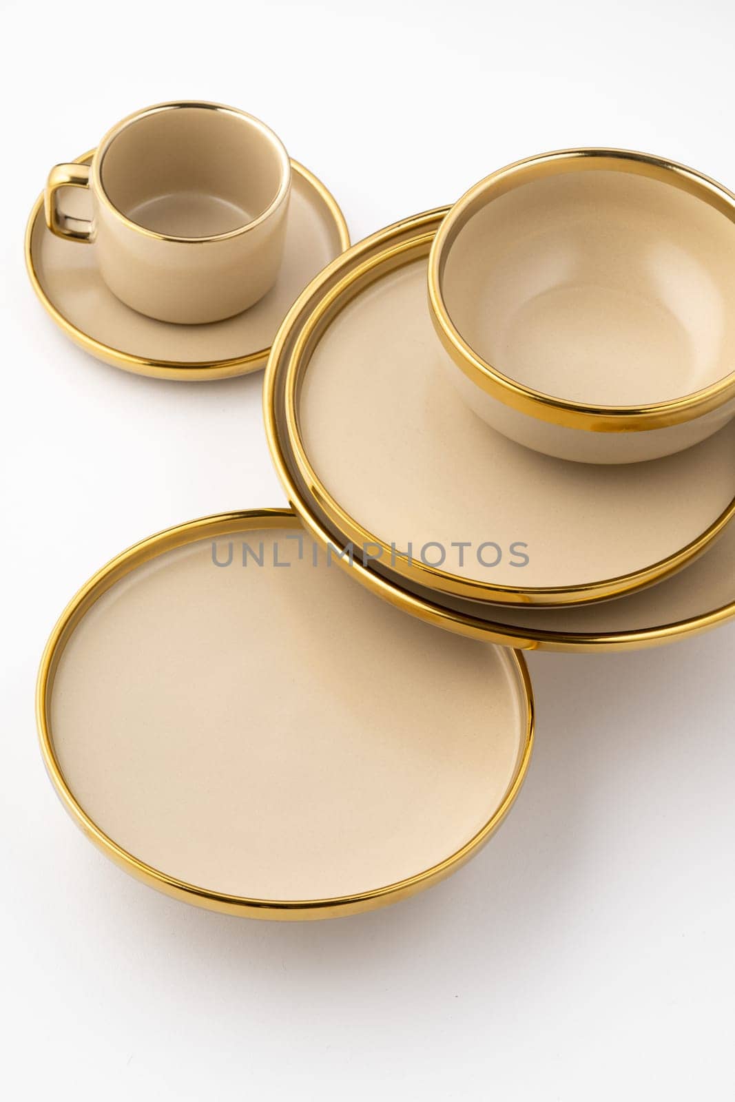 A Set of light brown ceramic plate and cup on a white background