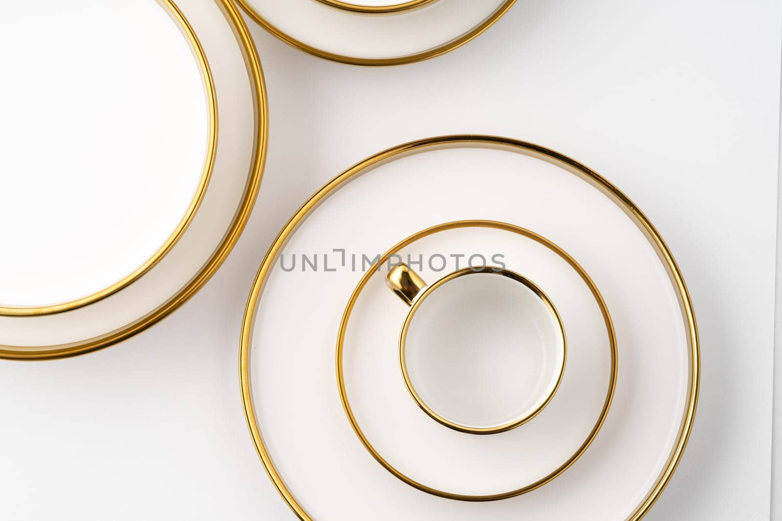 A set of white and brown ceramic plate and cup on a white background. Top view