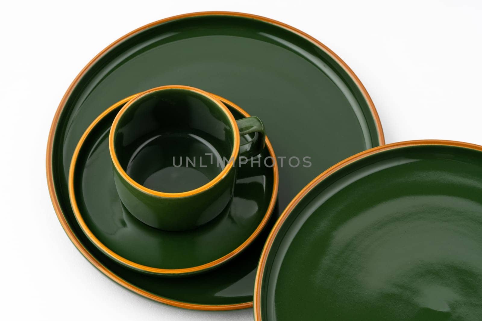 A set of dark green ceramic tableware with orange outlines on a white background by A_Karim