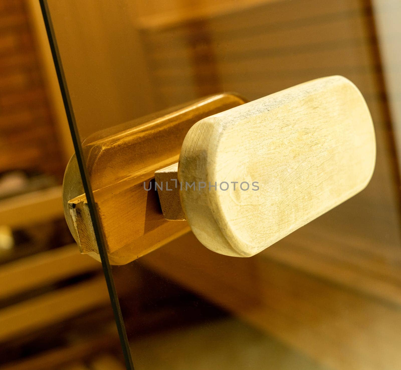 A closeup of a door handle of the sauna in the sports complex by A_Karim