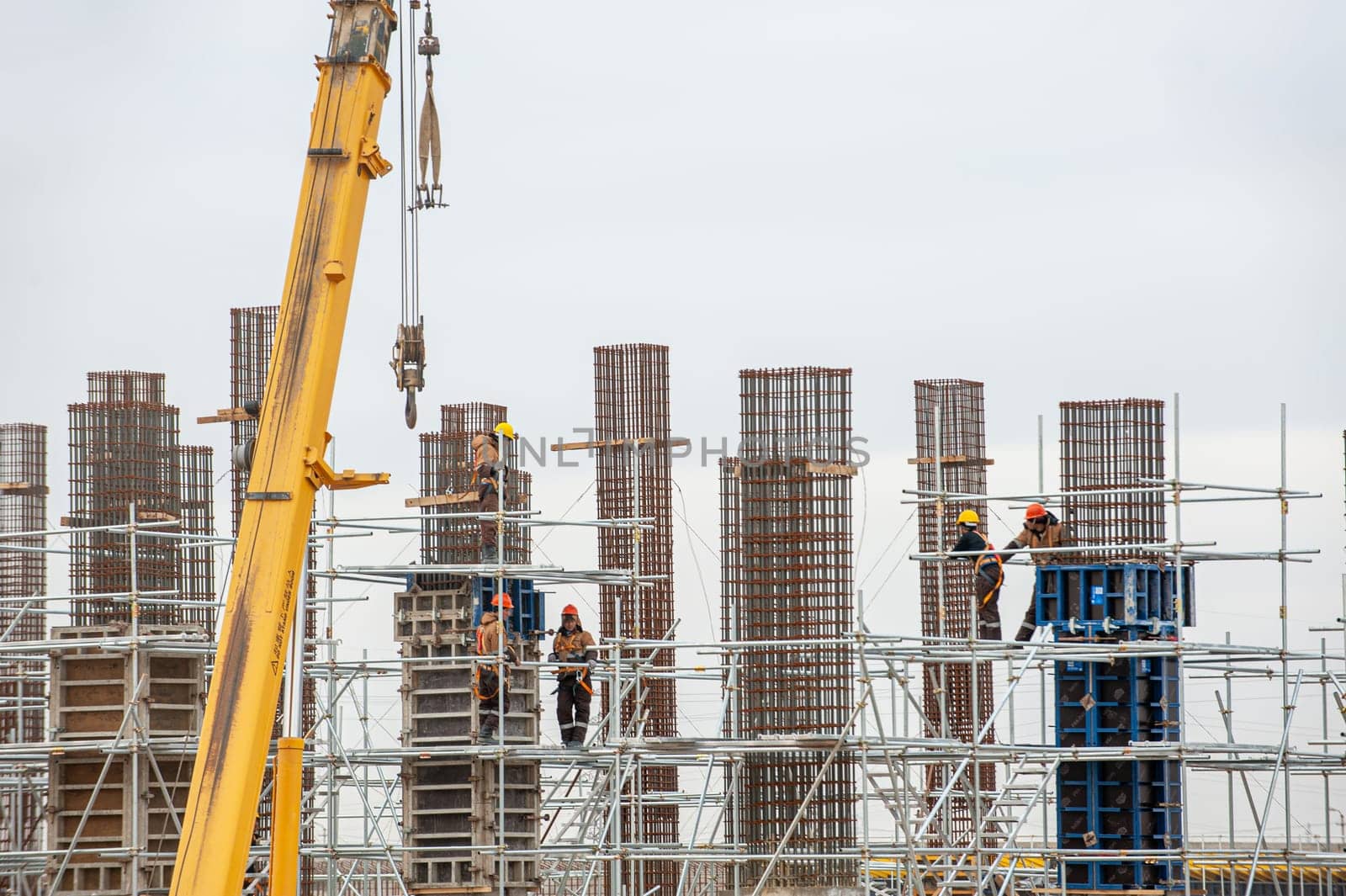 A workers with special equipment in a construction site make formwork