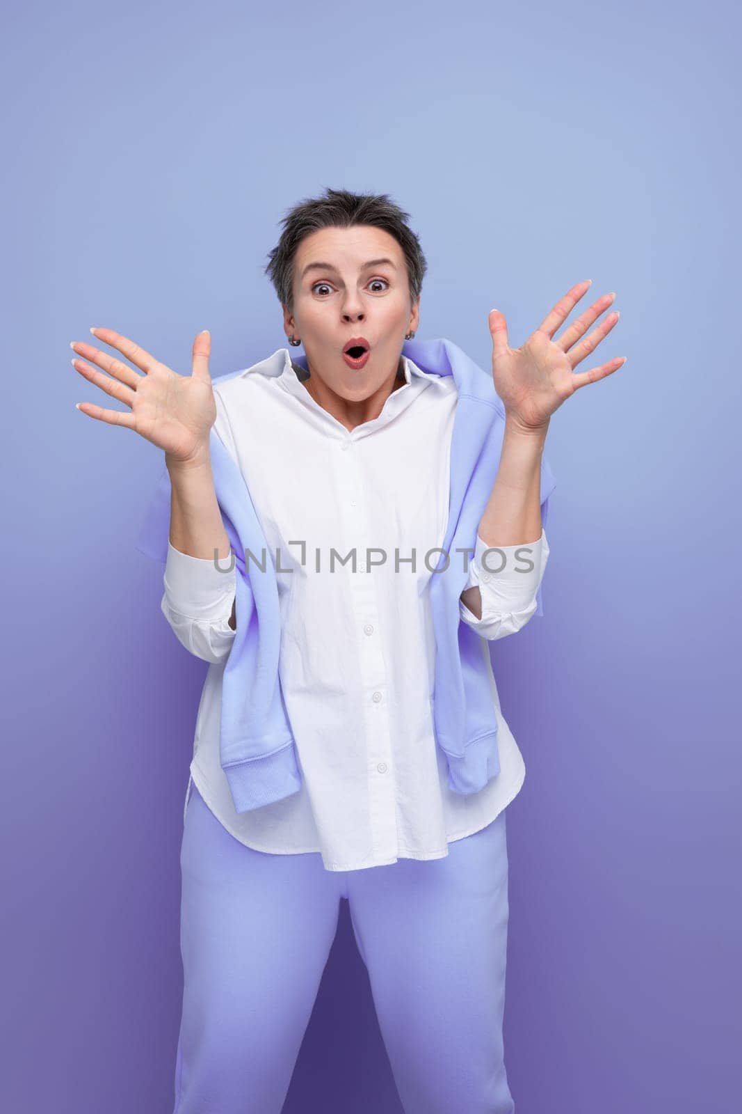 shocked brunette with hair sticking out young woman in casual look.