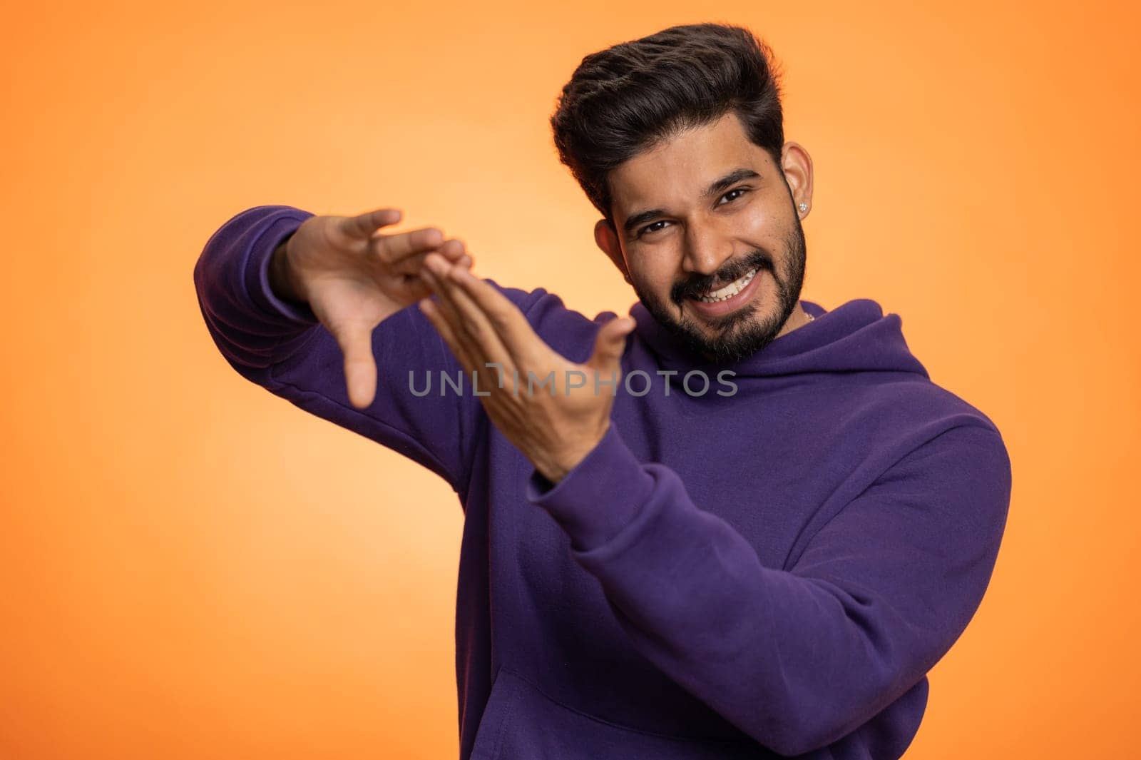 Indian man showing wasting, throwing money around, more tips, big profit, winning lottery jackpot, successful shopping payment purchase, cashback, victory celebrate. Hindu guy on orange background