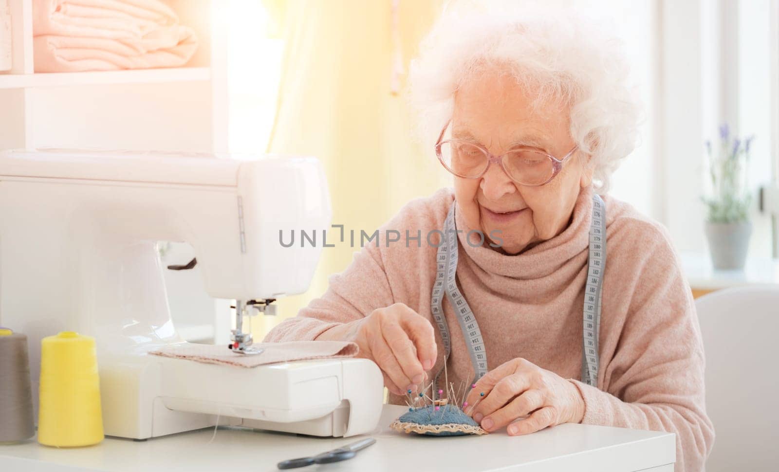 Lovely aged woman sewing by GekaSkr
