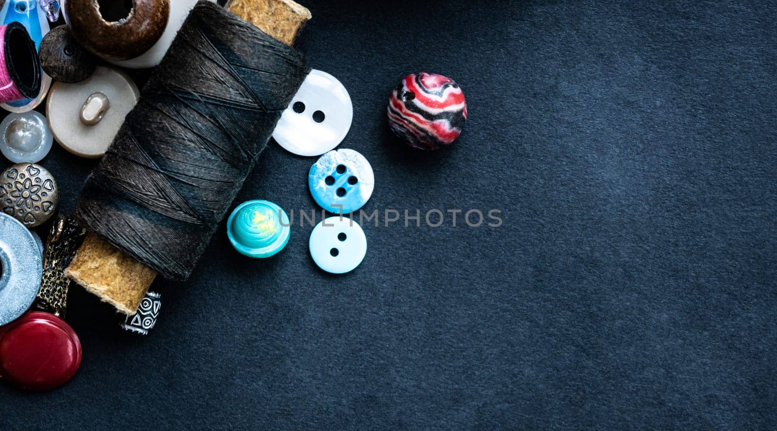 Sewing supplies macro with copy space on dark background