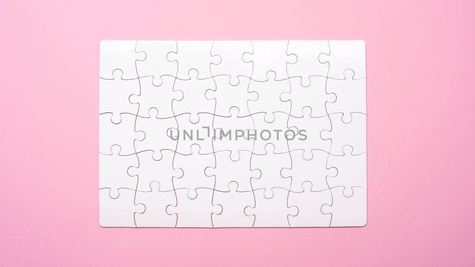 Blank finished rectangular puzzle on pink background