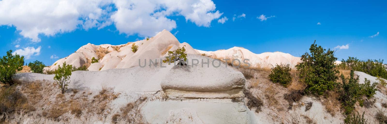 Panoramic view of sand mountain under clear blue sky in Cappadocia, Turkey