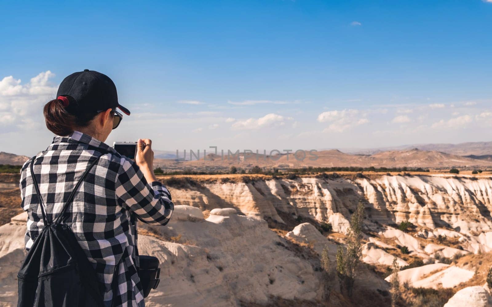 Tourist photographing canyon in Cappadocia, Turkey by GekaSkr